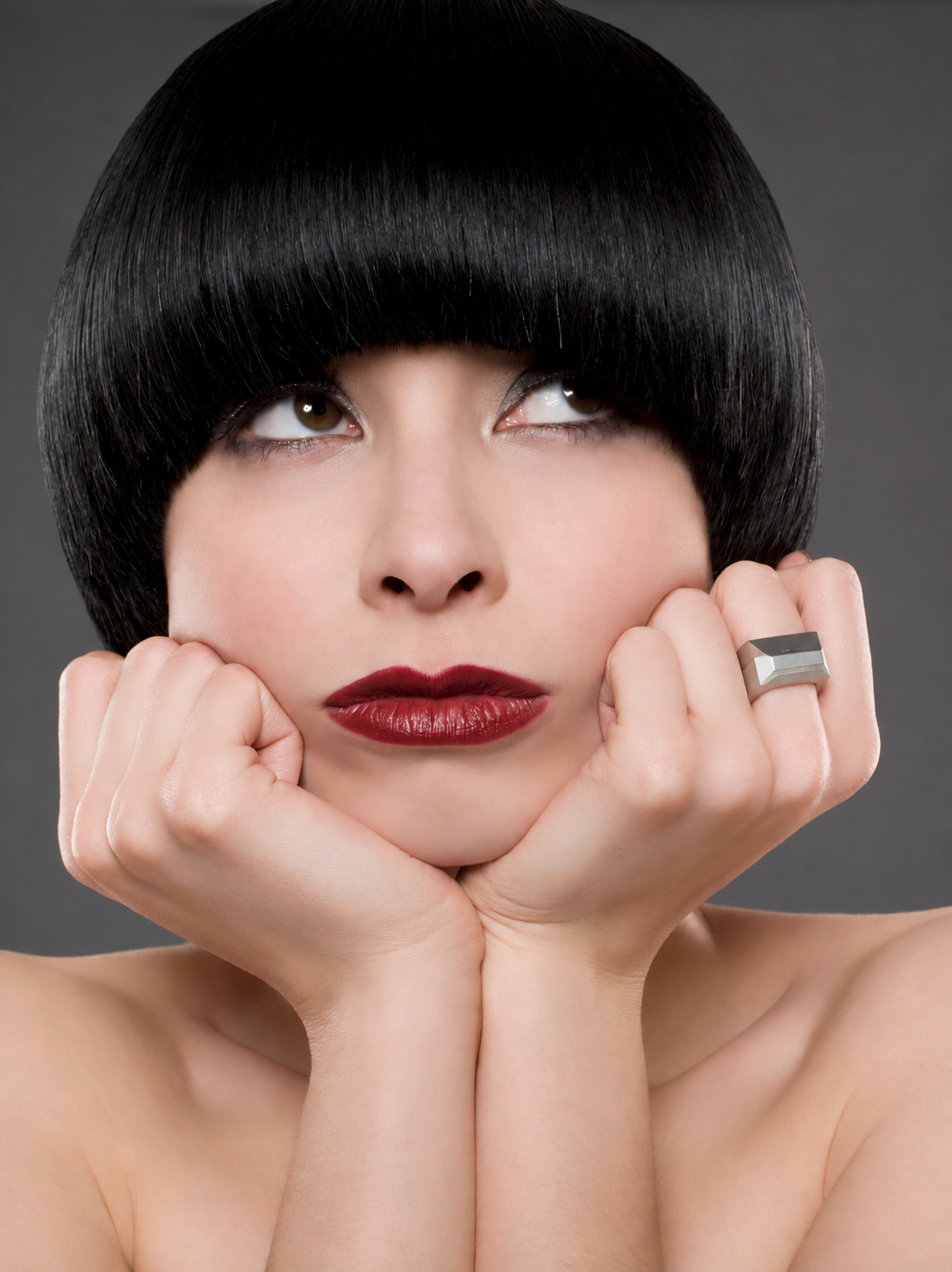 Close portrait of a model wearing a geometric silver ring
